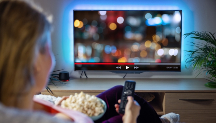 An undated image of a woman watching TV. — Canva