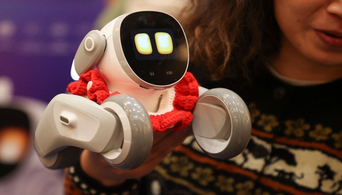 KEYi Technology Partnership Coordinator Vivi Zhang holds Loona, an AI pet, during Pepcom ahead of the Consumer Electronics Show (CES) in Las Vegas, Nevada on January 6, 2025. — AFP
