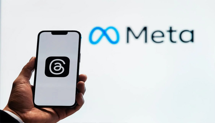 An undated image of Threads app logo on a smartphone and Meta on the background. — Pexels