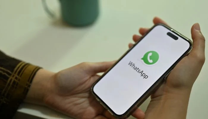 An undated image of a woman using WhatsApp on phone. — Canva
