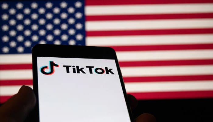 An undated image of TikTok, along with American flag in background. — Getty Images