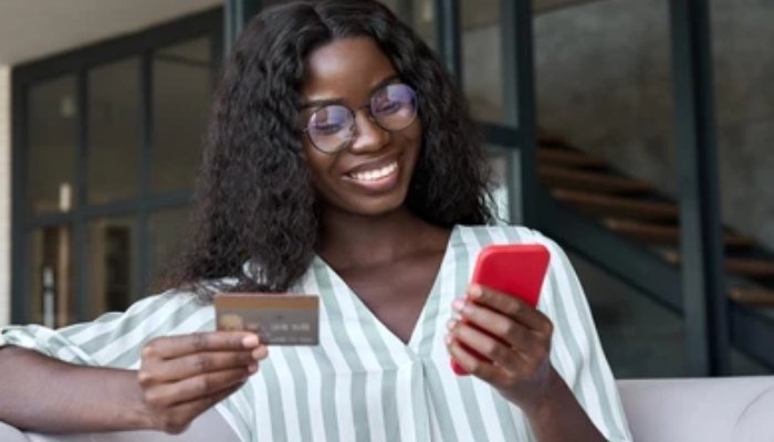 An undated image of girl using debit card. — Shutterstock