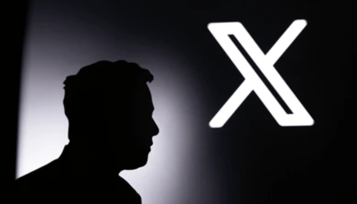 An undated image of Elon Musk silhouette in front of social media X logo. — Shutterstock