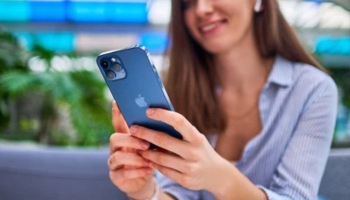An undated image of a girl using her iPhone. — Shutterstock