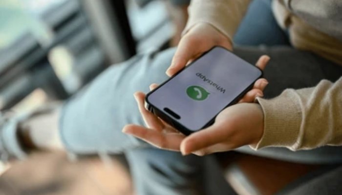 An undated image of WhatsApps logo displayed on a phone. — Shutterstock