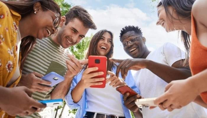 An undated image of group of people using their phones. — Shutterstock