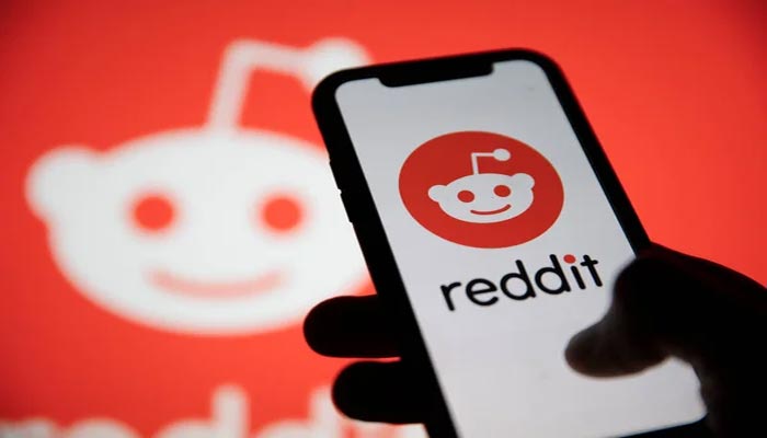 An undated image of Reddit logo seen on smartphone, along with background. — Depositphotos