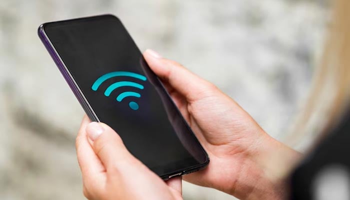An undated image of Wi-Fi logo seen on smartphone. — Adobe Stock