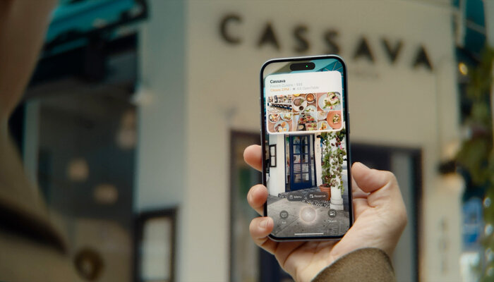 An undated image of a person using Visual Intelligence with Camera Control on an iPhone. — Apple