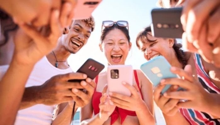 An undated image of group of people using their smartphones. — Shutterstock