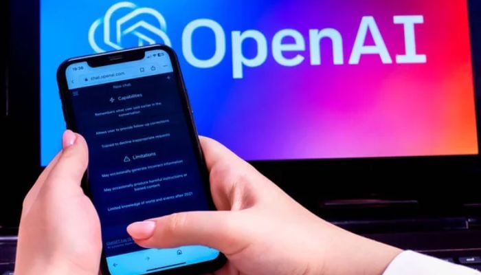 An undated image of a person using a smartphone with OpenAI logo in background. — Depositphotos