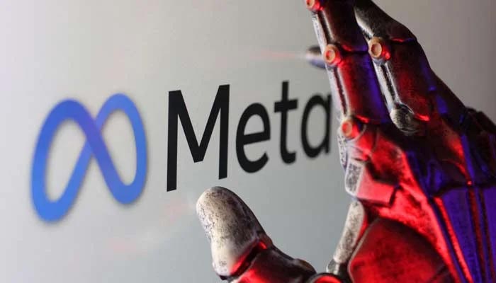 This representational image shows Meta logo and a robotic hand. — Reuters/file