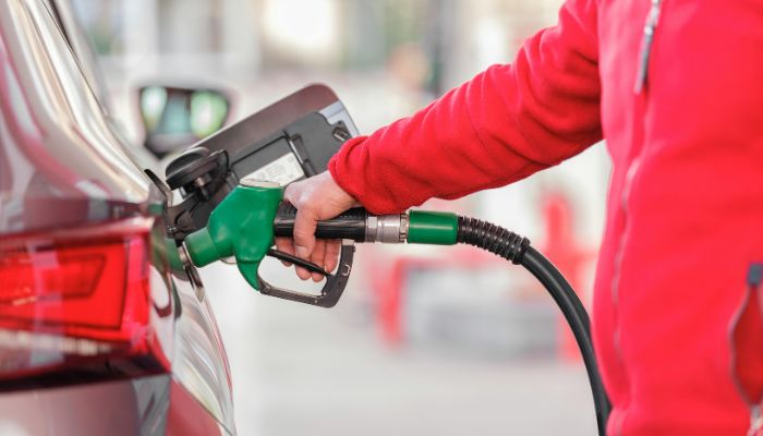 An undated image of a person filling petrol in car. — Canva