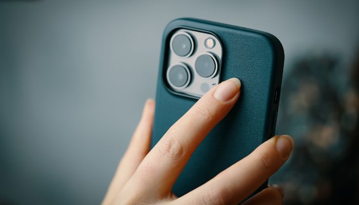 An undated image of the a person holding iPhone. —  Canva