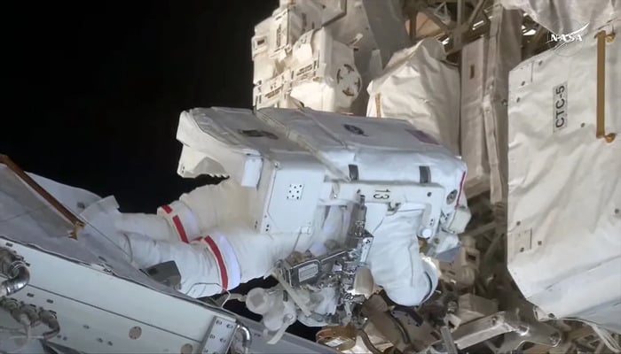 NASA astronaut Anne McClain adjusts a foot restraint during a May 1, 2025 spacewalk outside the ISS. — NASA