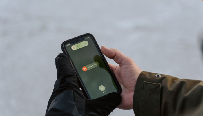 An undated image of a person using the emergency alerts feature. — Canva