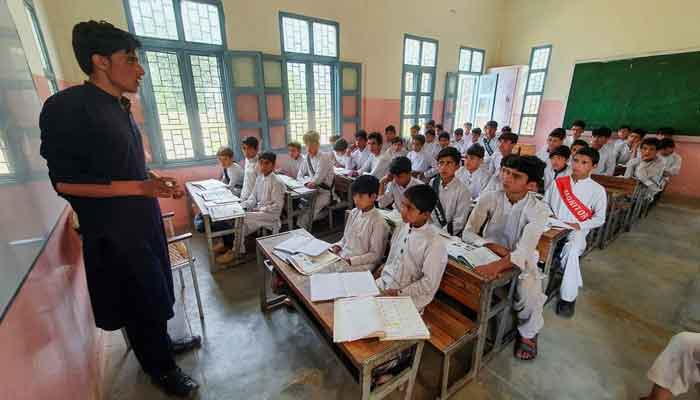 An undated image showing school teacher teaching young kids at a Pakistani school. — Reuters