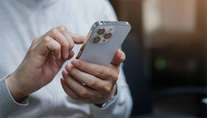 An undated image of person using iPhone. — Shutterstock