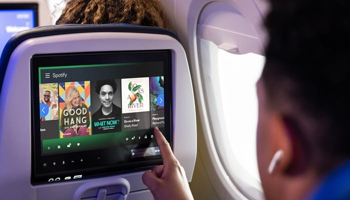An undated image of a passenger using Spotify in United Airlines. — Spotify blog