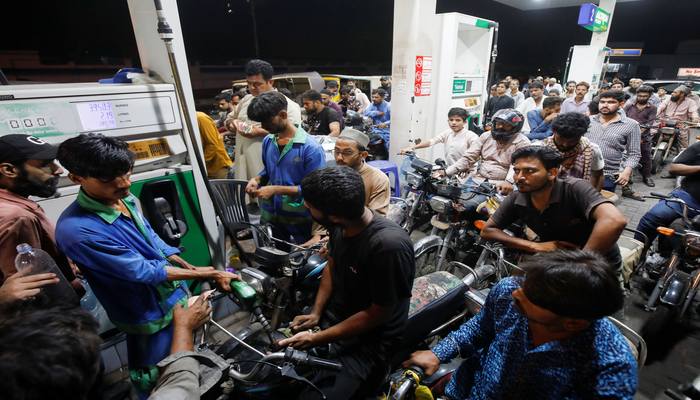 People wait their turn to get fuel at a petrol station, in Karachi, Pakistan June 2, 2022. — Reuters